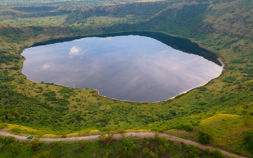 An aerial view of a crater lake in Queen Elizabeth National Park