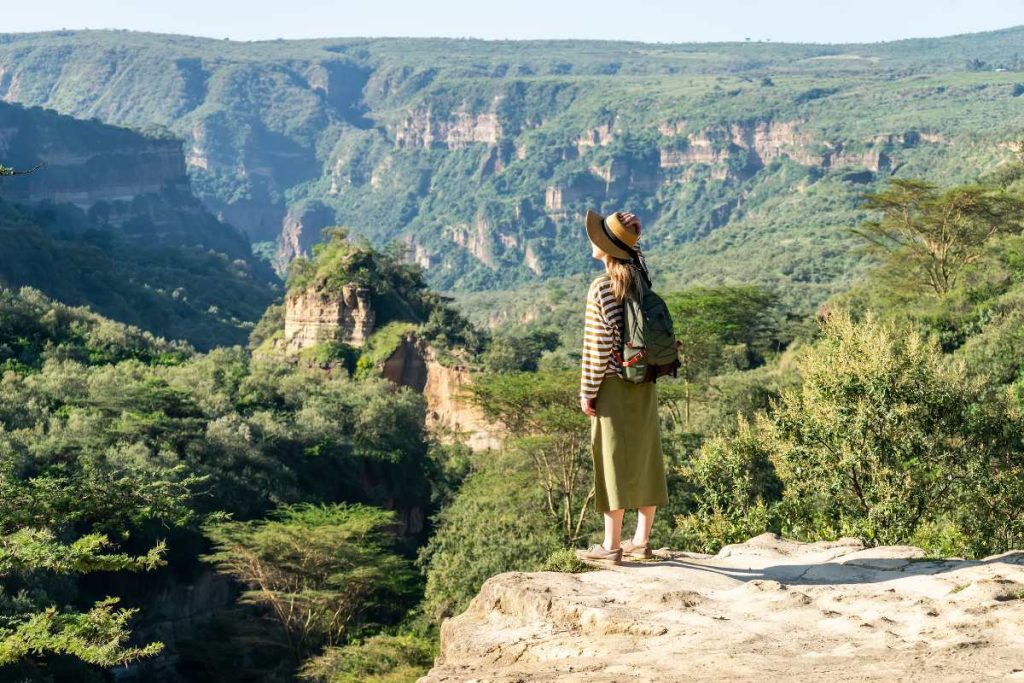 A female traveler on a walking safari in Hells gate national park