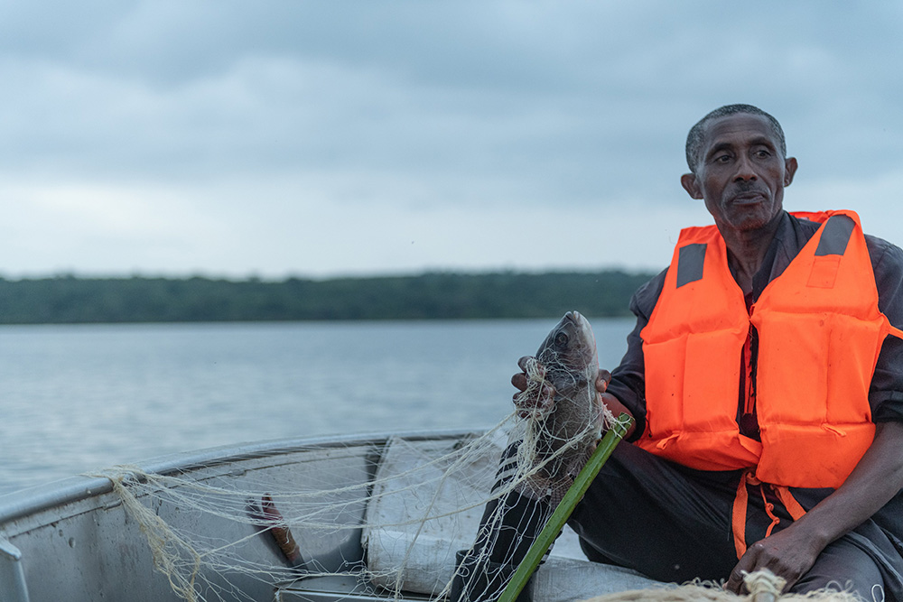 A fisherman holding fish