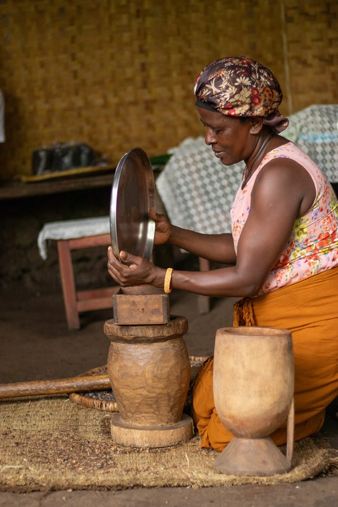 A lady preparing Ugandan coffee locally during a community visit at the Bigodi Community Walk - BICOWA
