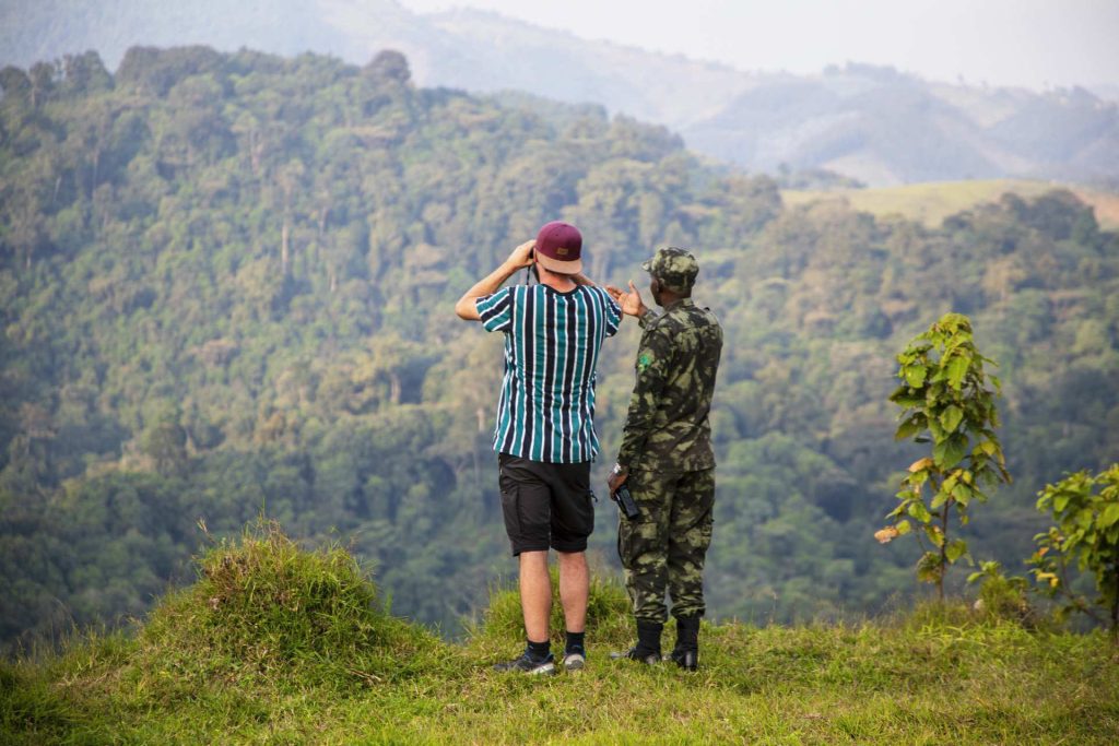 A tourist enjoying views of Gishwati Mukura National Park