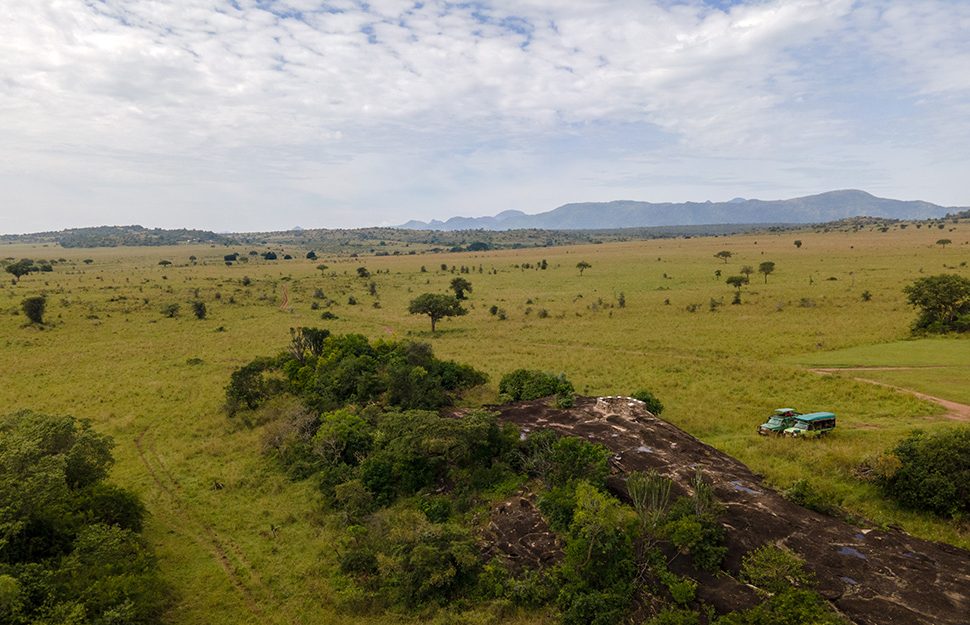 Tourists watching lions in Kidepo Valley National Park