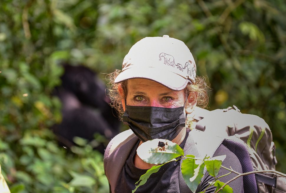 A tourist takes a selfie with a mountain gorilla during a gorilla habituation experience in Bwindi