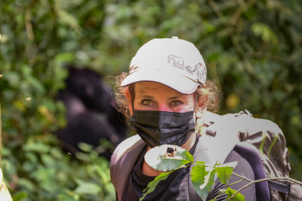 A tourist takes a selfie with a mountain gorilla during a gorilla habituation experience in Bwindi