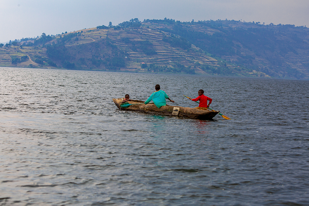 Lake Bunyonyi residents navigation the lake in dug out canoes